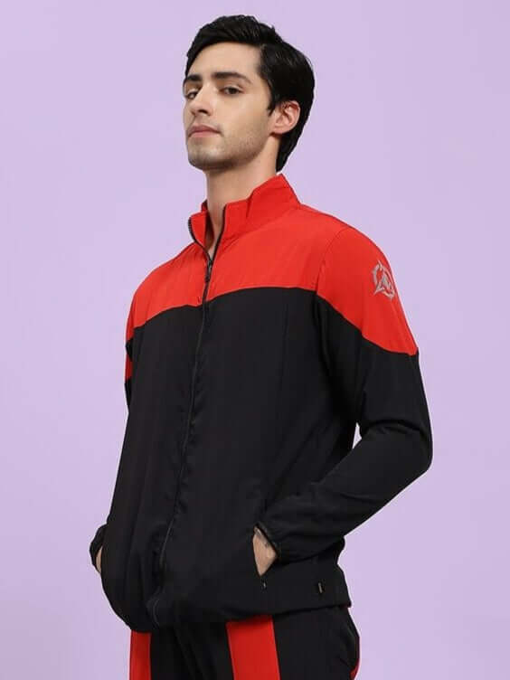 POWER BLOCK RELAXED FIT JACKET BLACK RED Person wearing a black and red jacket on a light purple background