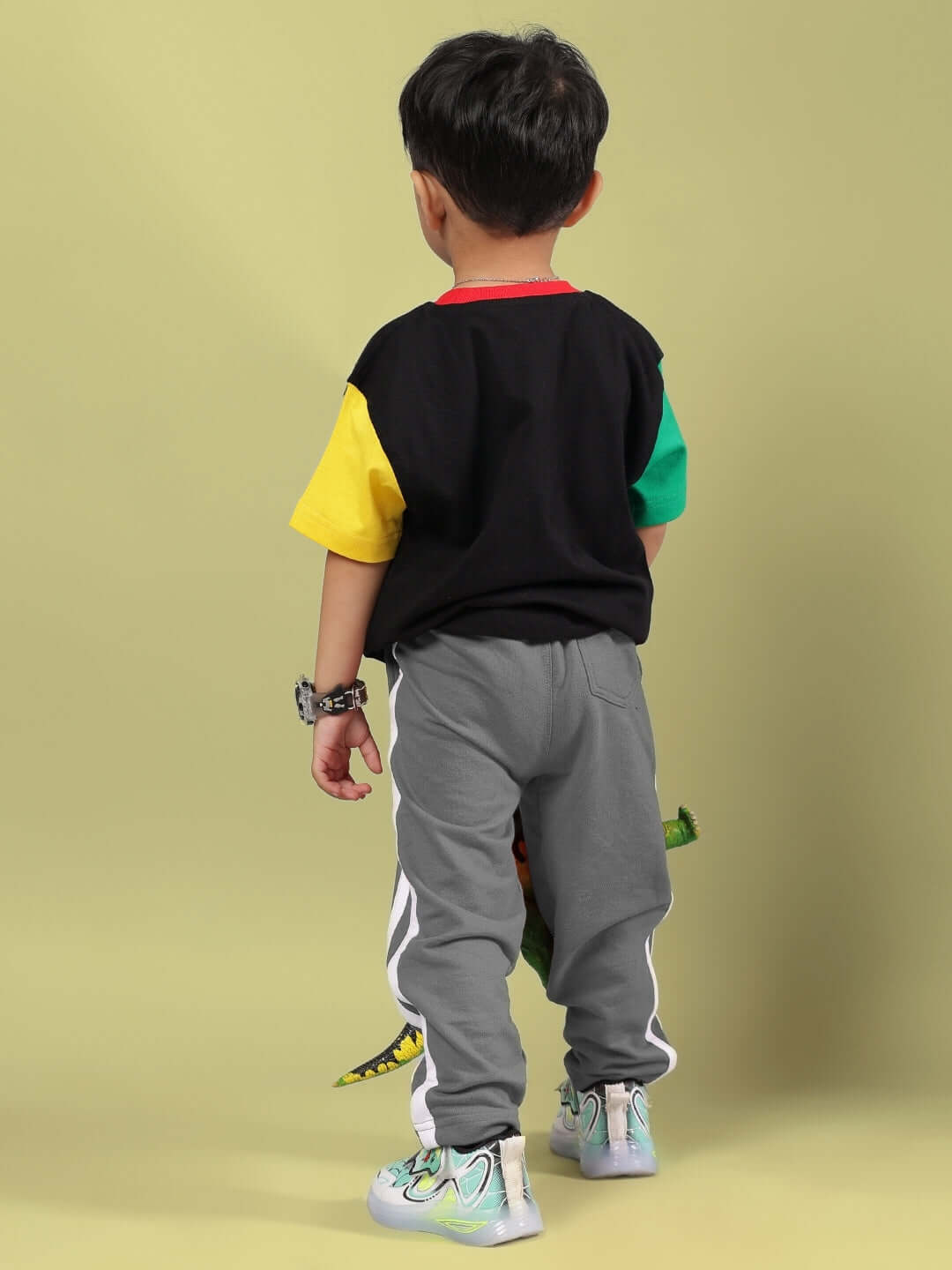 Child wearing a colorful black and grey mocha co-ord set from DUDS, featuring custom fit options.