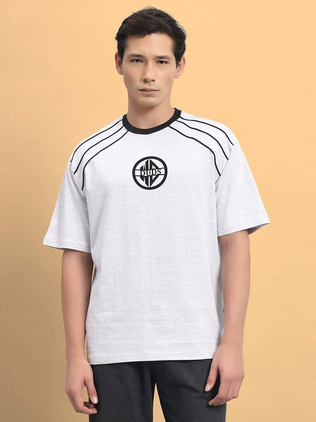 Model wearing PERCY OVER-SIZED T-SHIRT MELANGE GREY made from premium cotton French terry, showcasing casual style and comfort.