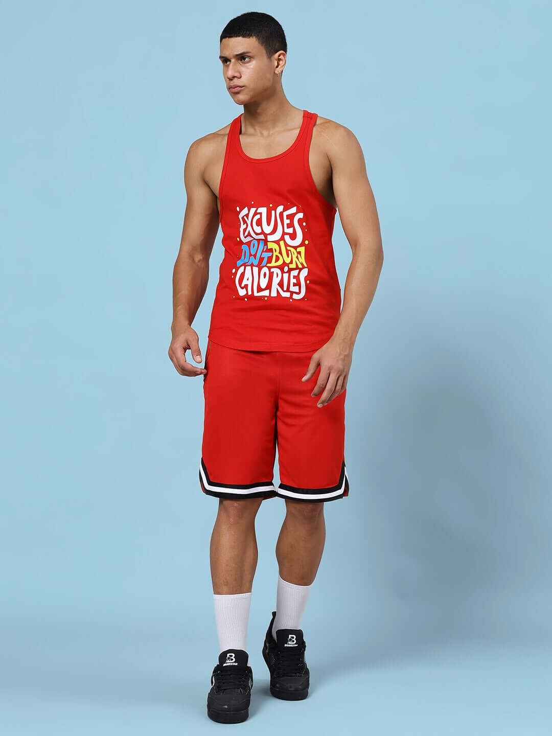 Red gym co-ord set with 'Excuses Don't Burn Calories' print, featuring premium cotton T-shirt and sports polyester shorts for active wear.