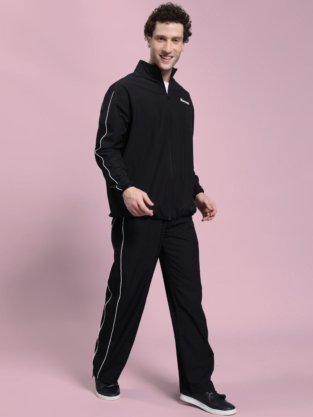 Man wearing RELIGHT RELAXED FIT CO-ORD SET BLACK with thermal-regulating fabric, designed for comfort and style, featuring an oversized hoodie.