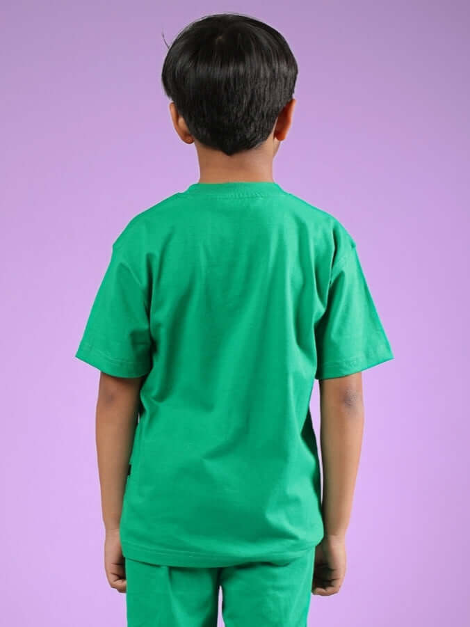 Back view of a child wearing a green Satoru t-shirt, made for both boys and girls by DUDS. Custom fit option available for prepaid orders.