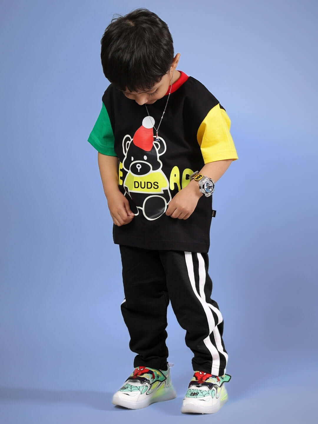 Child wearing a colorful, customized black DUDS mocha co-ord set for boys and girls with vibrant accents, made-to-order.