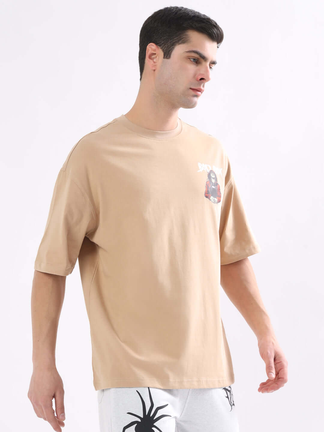 Man wearing BAD BOY OVER-SIZED T-SHIRT NUDE in premium heavy gauge fabric, showcasing relaxed fit and style.