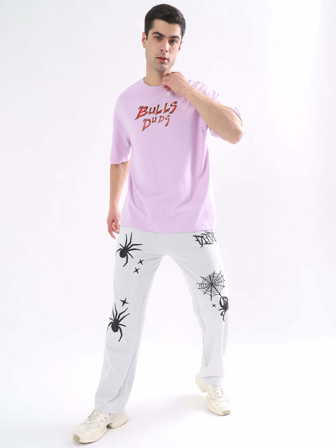 Model wearing Wild Bull Over-Sized T-Shirt Lavender and graphic pants, showcasing streetwear style and comfort.