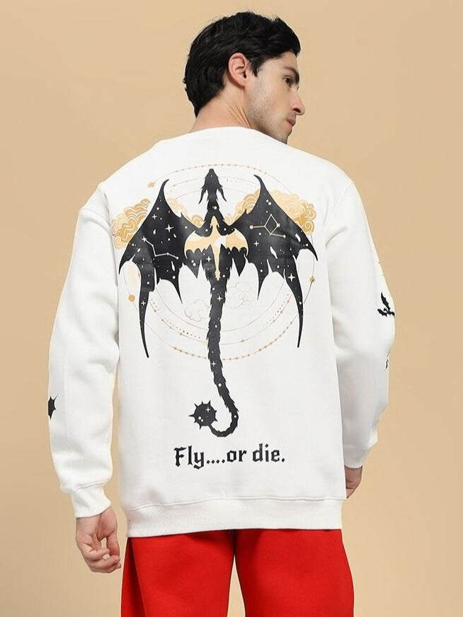 Person wearing a white sweatshirt with a dragon design and text on the back, standing against a beige background.