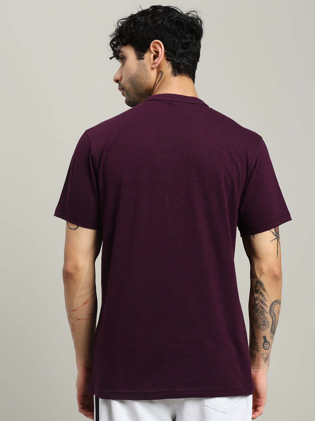 Back view of a man wearing an Albet regular fit purple T-shirt, made from 100% premium heavy cotton slub fabric.