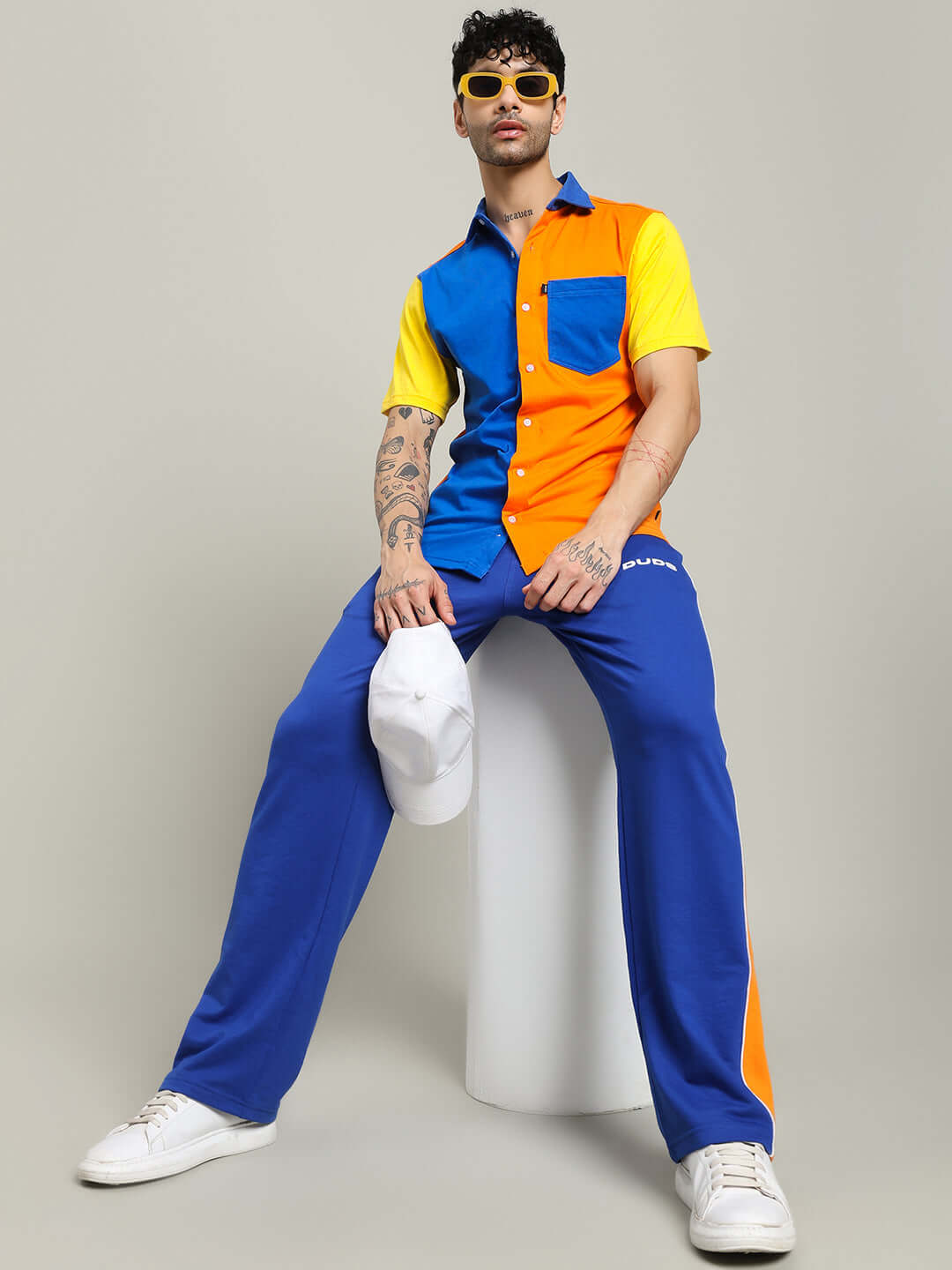 Model wearing APEX regular fit shirt in multi orange, showcasing vibrant colors and casual style with blue and orange accents.