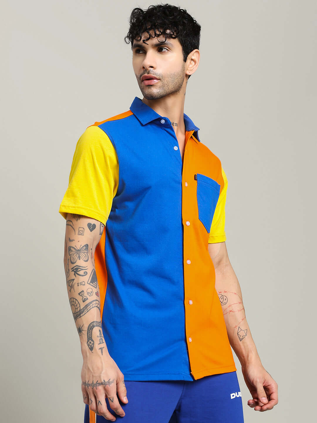 Model wearing APEX Regular Fit Shirt in multi-orange, featuring a vibrant color block design, available for custom fit only on prepaid orders.