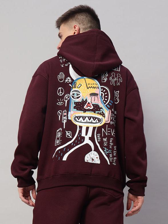 Back view of person wearing a JUMBLED PREMIUM HOODIE FLEECE in wine color with artistic graphic design.