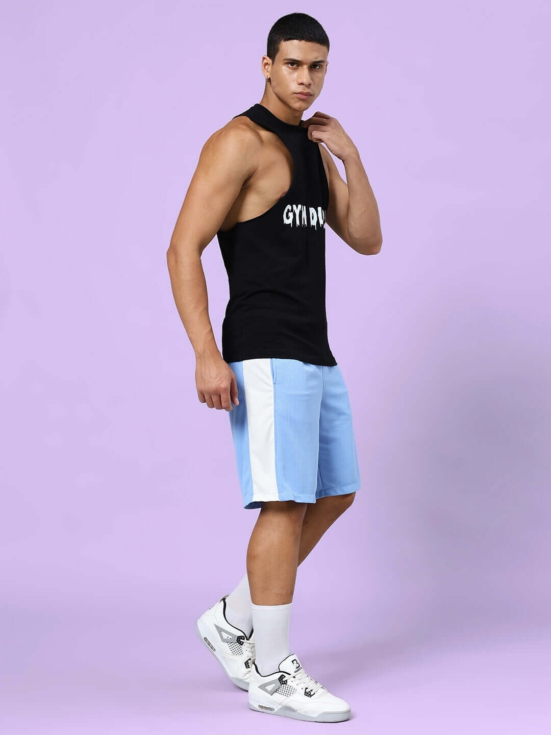 Model wearing Crunch Gym Co-ord Set in black and blue, featuring a heavy gauge cotton T-shirt and sports polyester shorts.