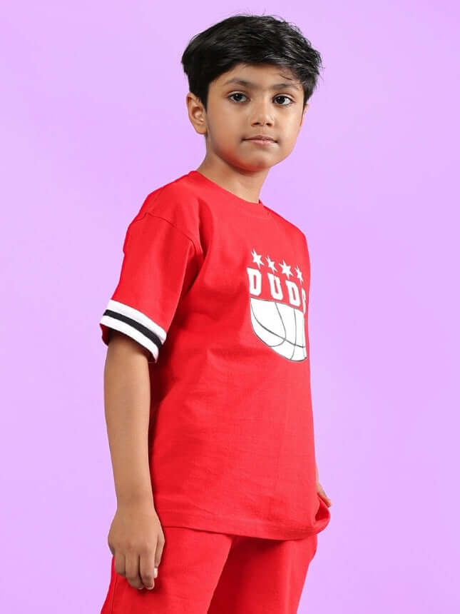 Child wearing red Diggin oversized t-shirt by DUDS, featuring a basketball graphic, perfect for boys and girls.