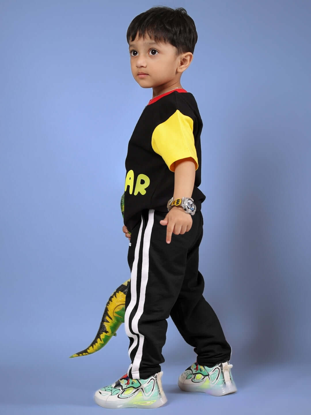 Child wearing black and yellow MOCHA co-ord outfit with side stripe pants, showcasing playful design and vibrant colors, suitable for boys and girls.