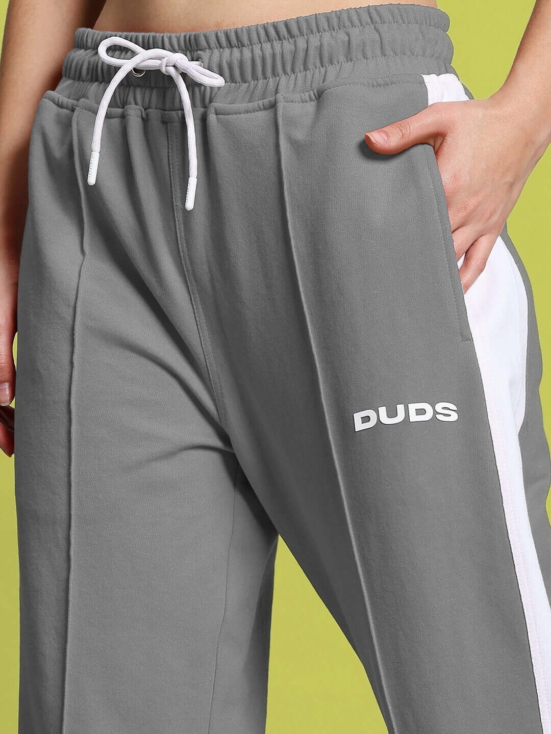 Close-up of DUDS Women's Wonder Slit Zipper Joggers in Grey-White, featuring adjustable waistband and logo detail.