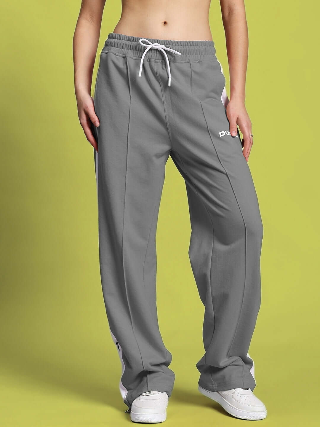 Woman wearing grey-white wonder slit zipper joggers by DUDS, showcasing tailored comfort and style, available in custom fit options.