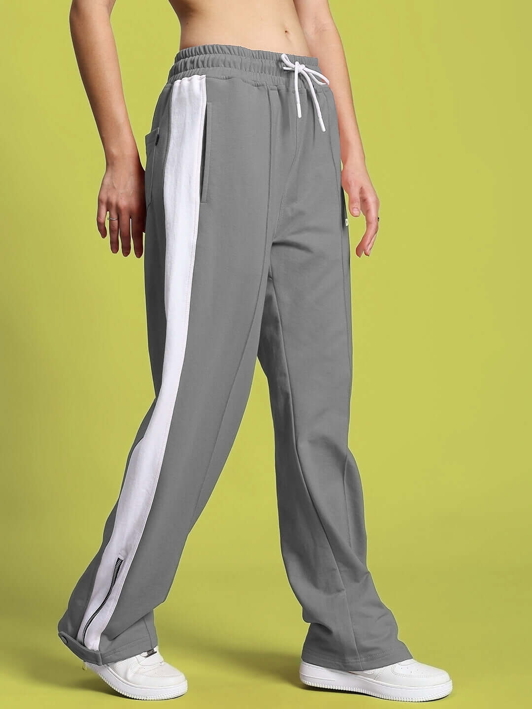 Women's grey-white Wonder Slit Zipper Joggers, featuring side stripes and drawstring waist, made by DUDS. Comfortable and stylish design.