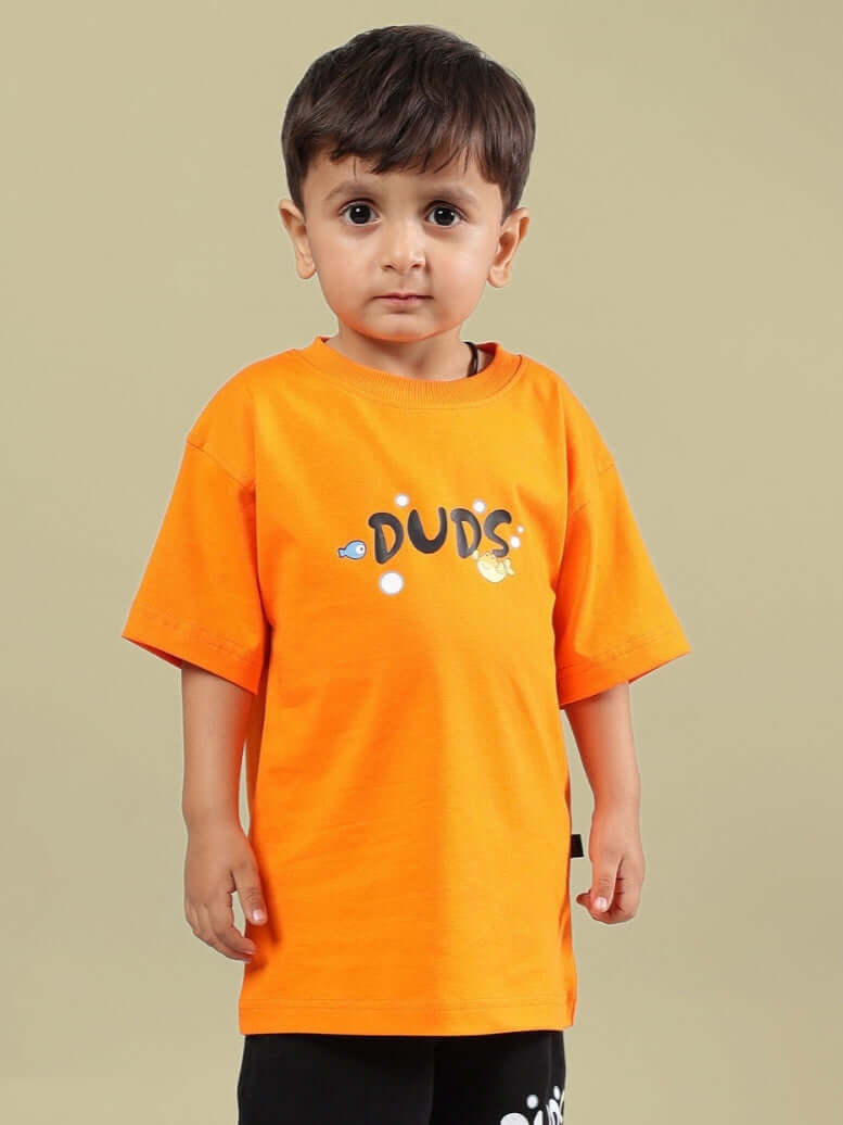Boy wearing an orange DUDS Diving Bear T-shirt, made for boys and girls. Custom fit available, ideal for kids' casual wear.
