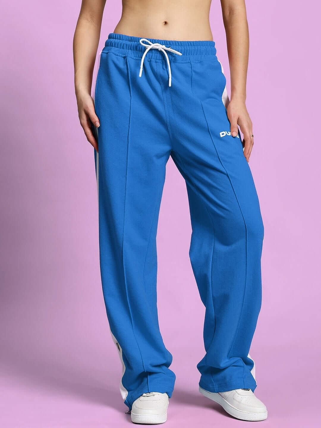Women's Wonder Slit Zipper Joggers in blue and white, featuring adjustable drawstring waist for customizable fit, showcased against a pink background.