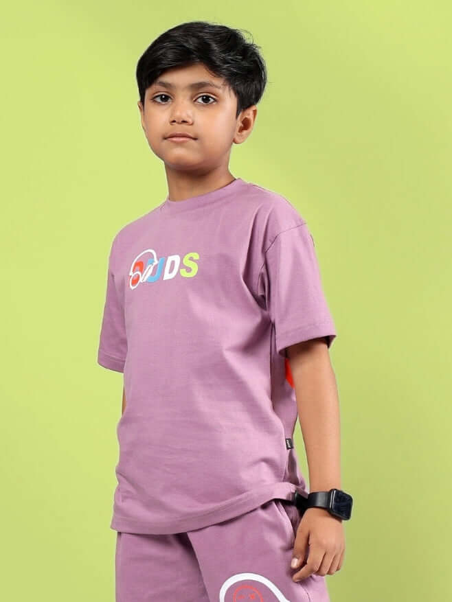 Boy wearing STOIC T-shirt in Pulm Purple by DUDS, made-to-order unisex apparel for kids, customizable size options available.
