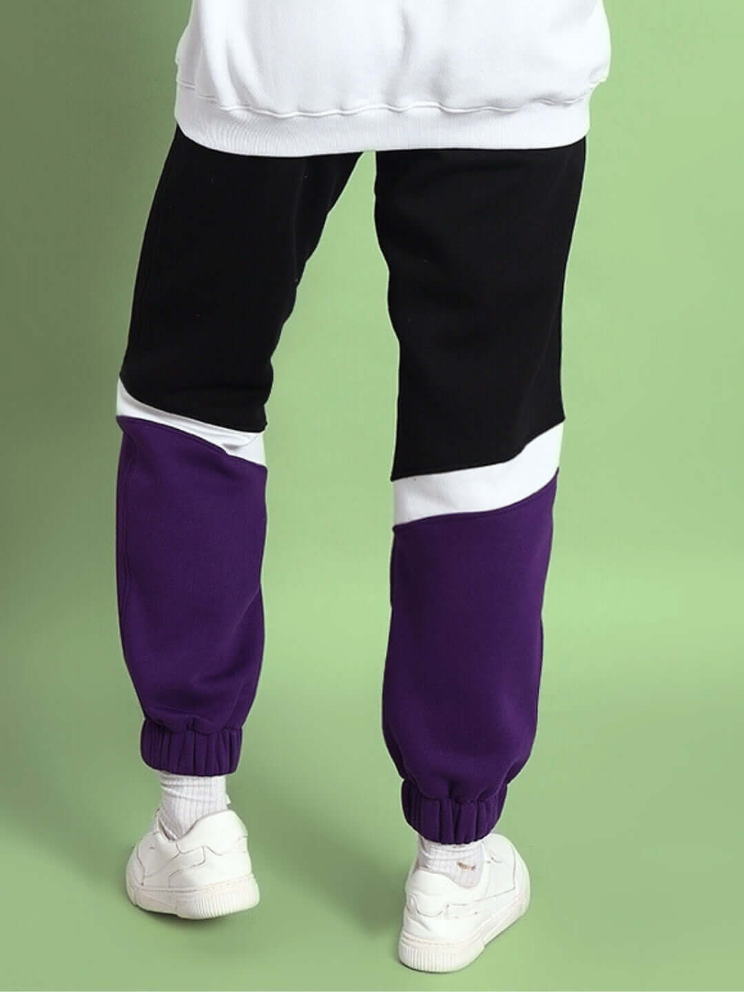 Women's Harley fleece colorblock jogger in purple, black, and white, shown from the back view on a green background.