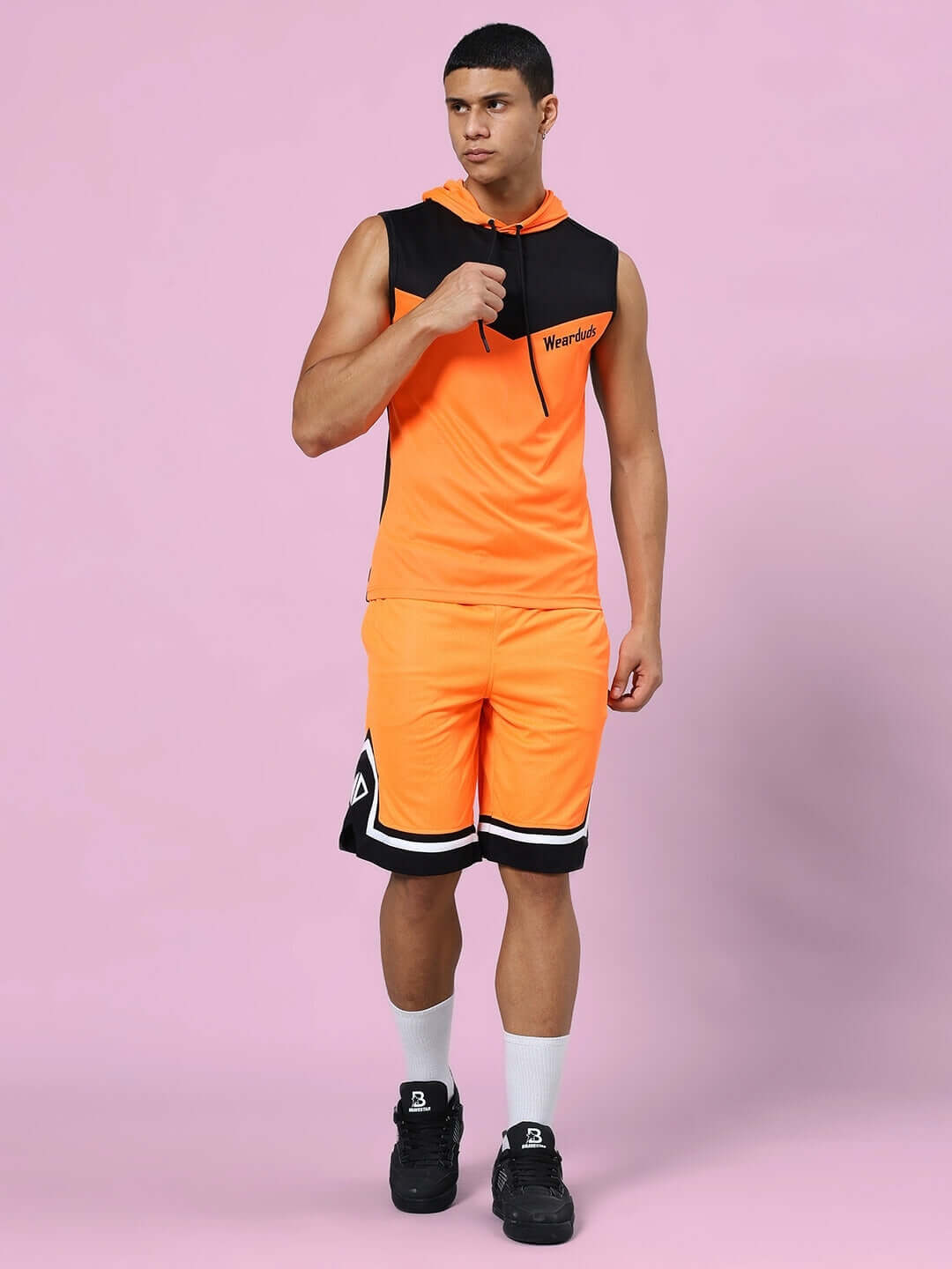 Man wearing Franky Gym Co-ord Set in orange and black, made of sports polyester fabric, ideal for workouts.