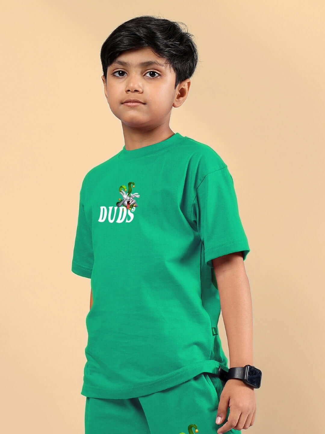 Child wearing green Looney Tunes printed t-shirt by DUDS, available for boys and girls, custom fit option, made to order.