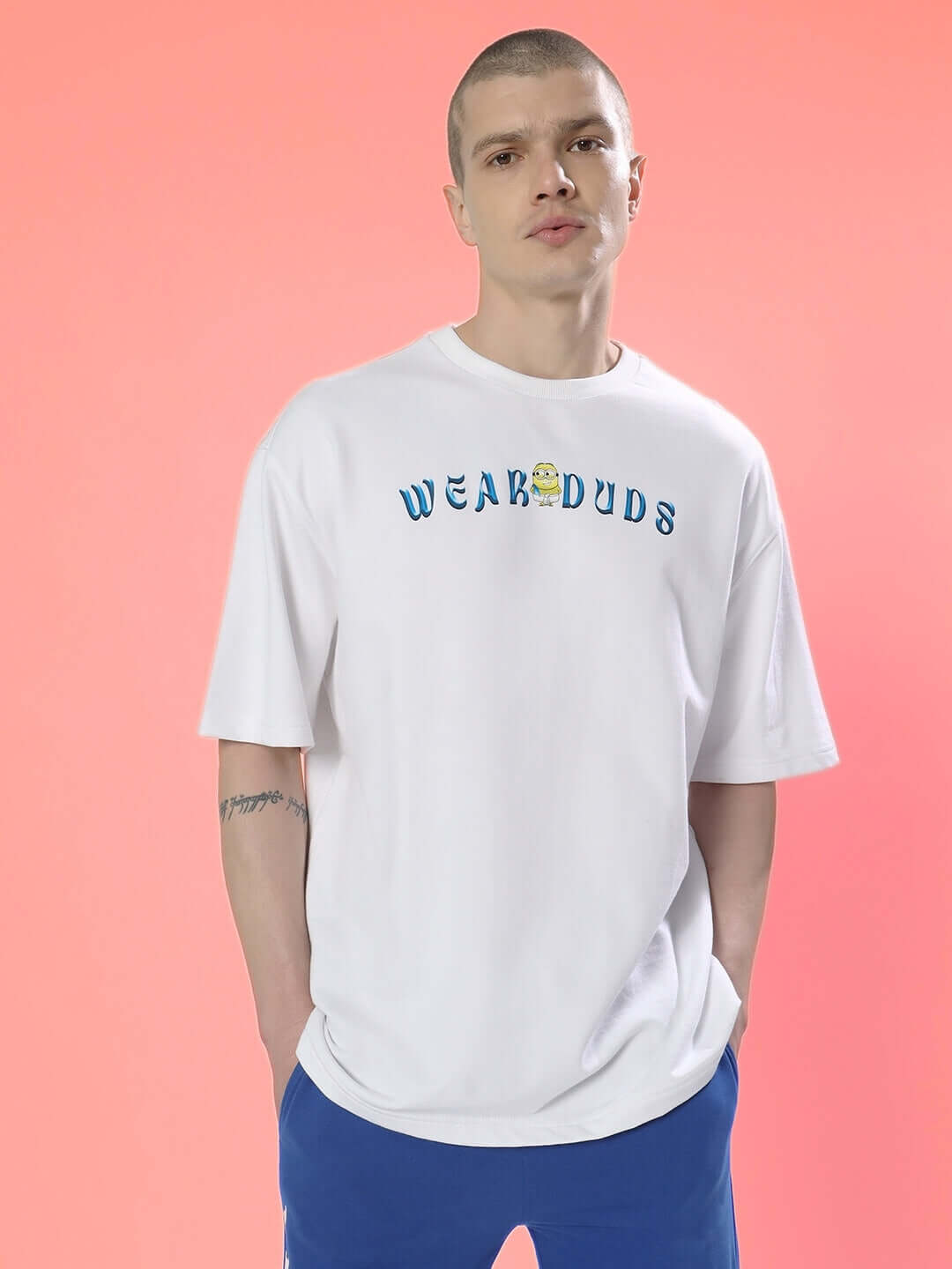 Man wearing SUBRAMIN MINION OVER-SIZED T-SHIRT WHITE with premium heavy gauge fabric made of 97% cotton and 3% elastane.