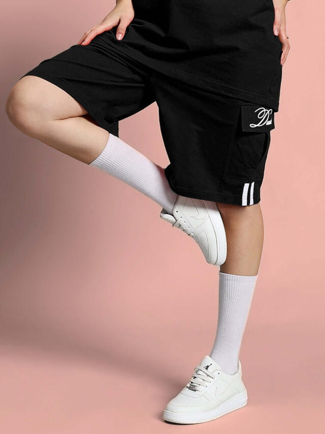 Women's black Scotia regular fit shorts with custom fit option, worn with white socks and sneakers.