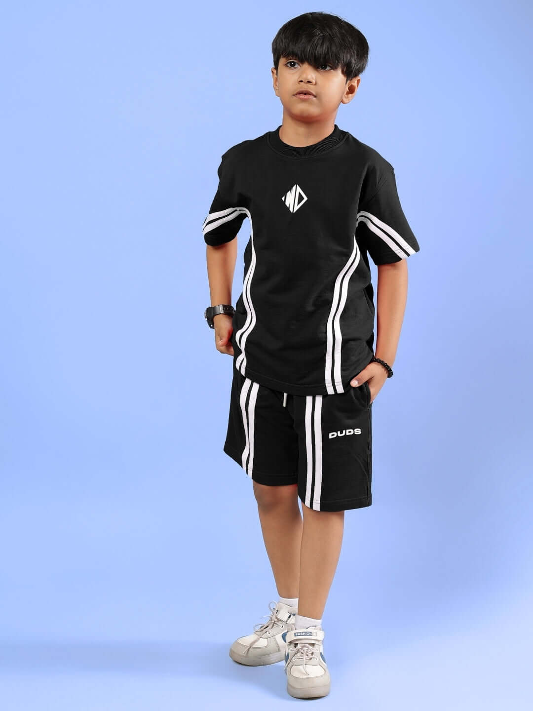 Alt Tag: Child wearing OUTLOOK Half Co-ord in black by DUDS, designed for both boys and girls, showcasing stylish and comfortable fashion.