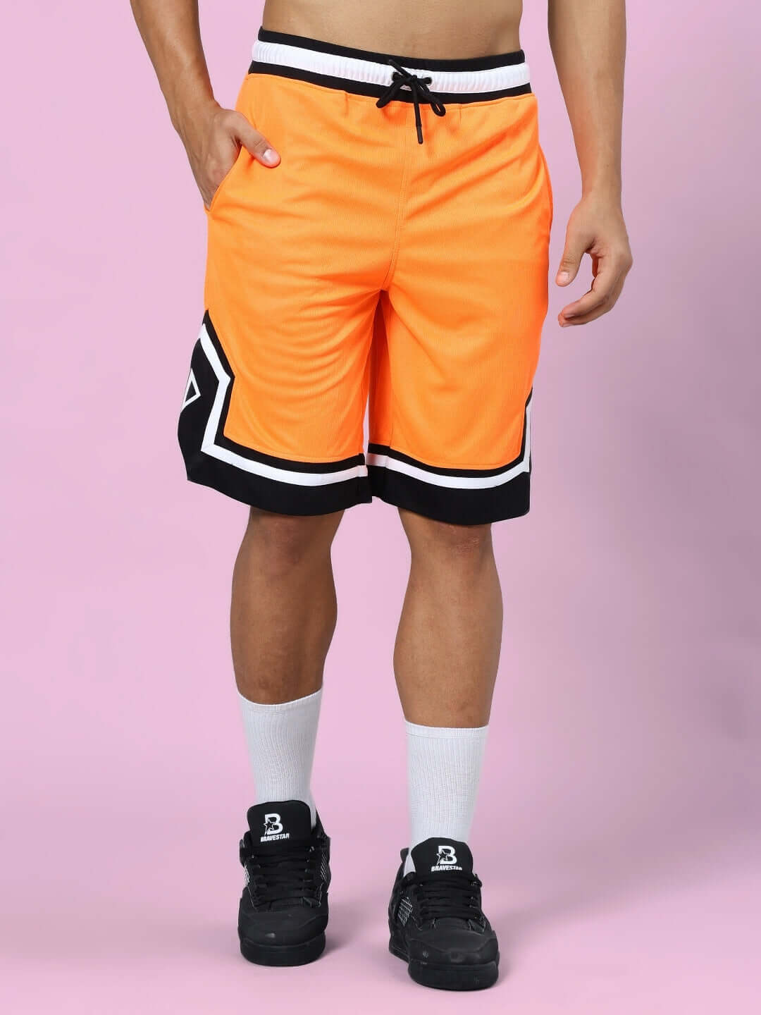 Orange Black Franky Gym Co-ord Set shorts, sports polyester fabric, styled with black sneakers, front view, pink background.