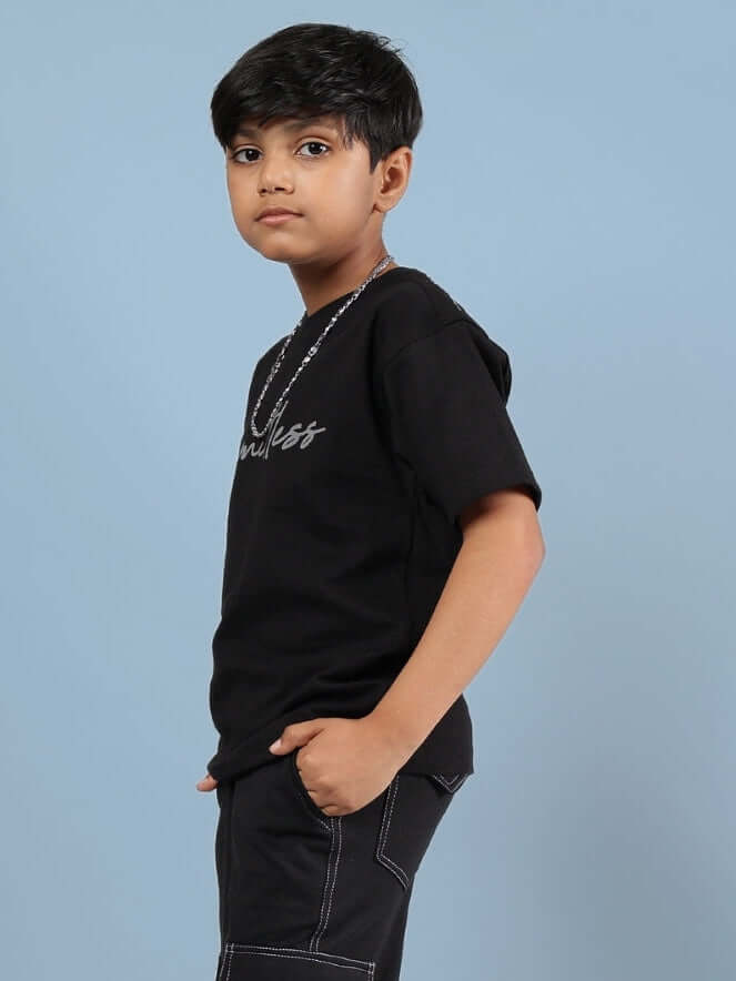 Child wearing a Limitless T-shirt for boys & girls in black, demonstrating a casual style; customizable size options available.