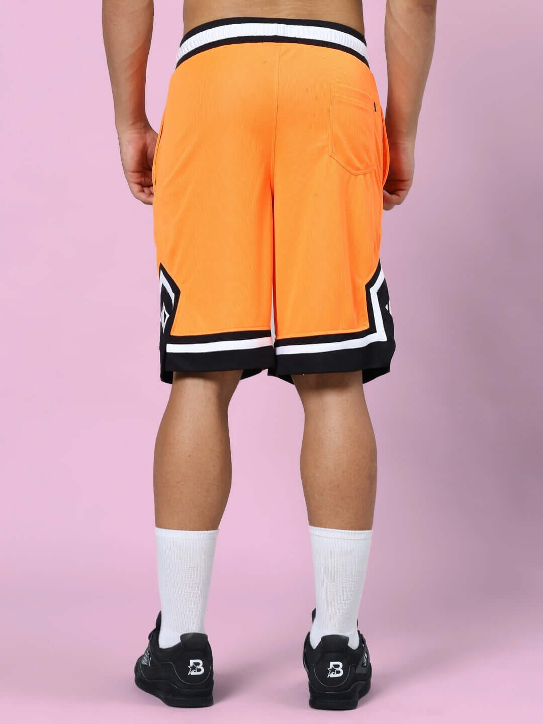 Back view of orange and black FRANKY gym co-ord shorts, featuring a stylish design with sports polyester fabric.