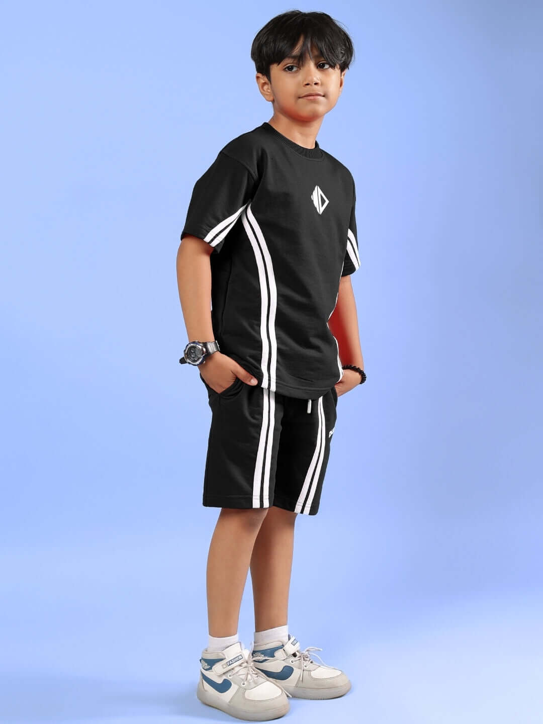 Young boy wearing black Outlook Half Co-ord set with white stripes, featuring comfortable fit and sporty style for boys and girls.