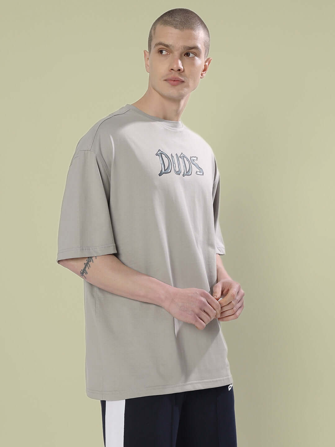 Man wearing POSITIVE RABBIT OVER-SIZED T-SHIRT GREY, premium heavy gauge fabric, 100% cotton, bio-washed, for a casual look.
