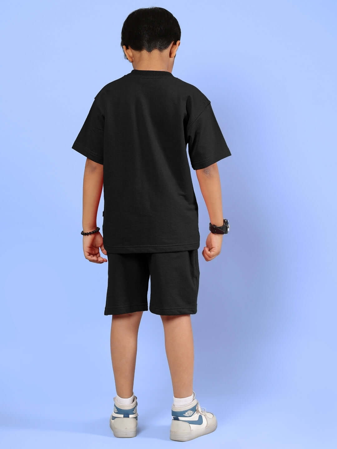 Child wearing black Outlook Half Co-ord set, featuring a t-shirt and shorts, suitable for boys & girls.