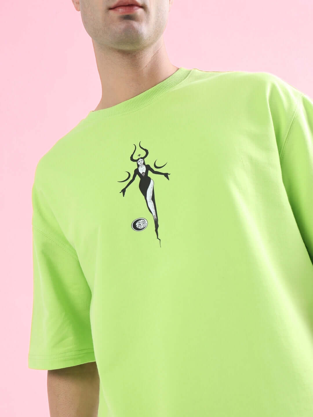Person wearing BLACK MOON OVER-SIZED T-SHIRT NEON GREEN with moon graphic, trendy streetwear fashion from WEAR DUDS.