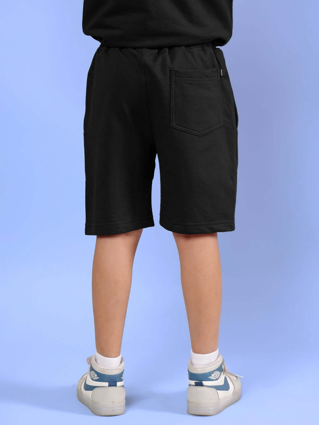 Child wearing black half co-ord shorts, part of the DUDS Outlook collection for boys and girls, showcasing a comfortable fit.