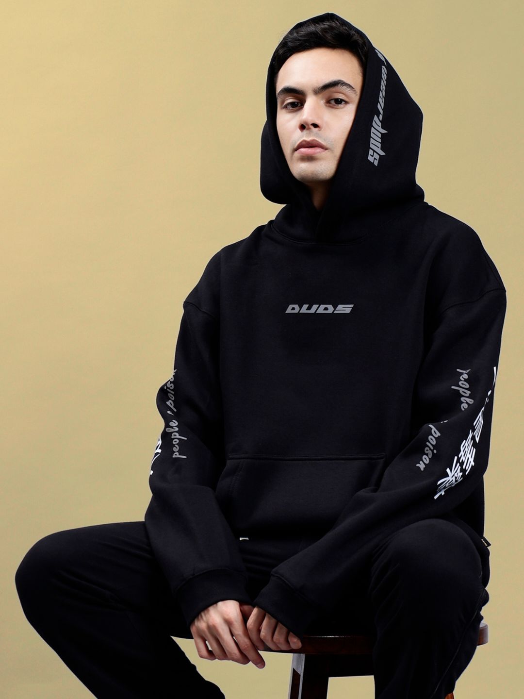 Model wearing POISON SKULL REFLECTOR OVERSIZE HOODIE BLACK in studio setting