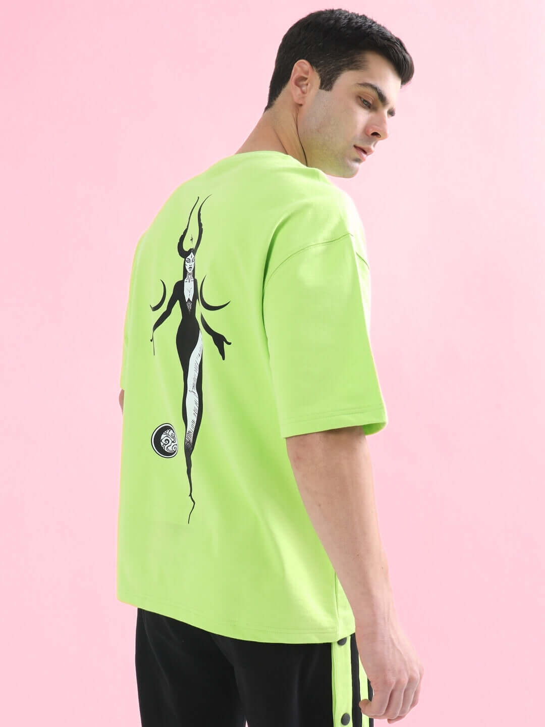 Man wearing BLACK MOON OVER-SIZED T-SHIRT NEON GREEN with moon graphic, streetwear style by WEAR DUDS.