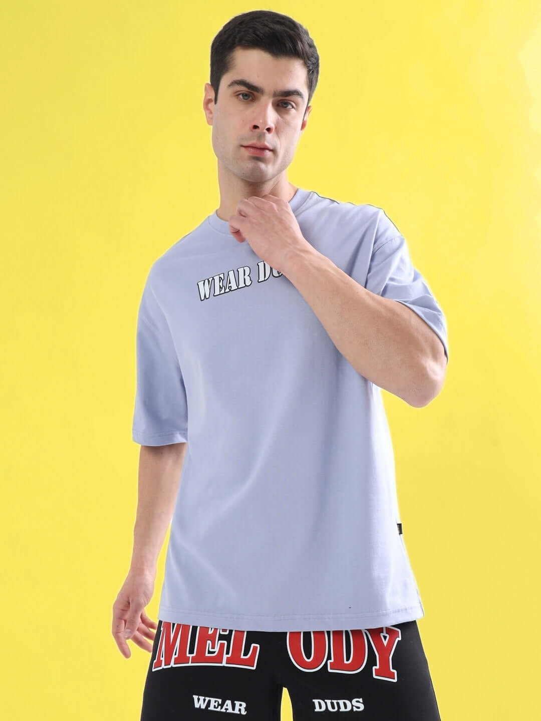 Model wearing RAPPER BUNNY OVER-SIZED T-SHIRT LILAC, made of premium heavy gauge 100% cotton fabric, in front of a yellow background.