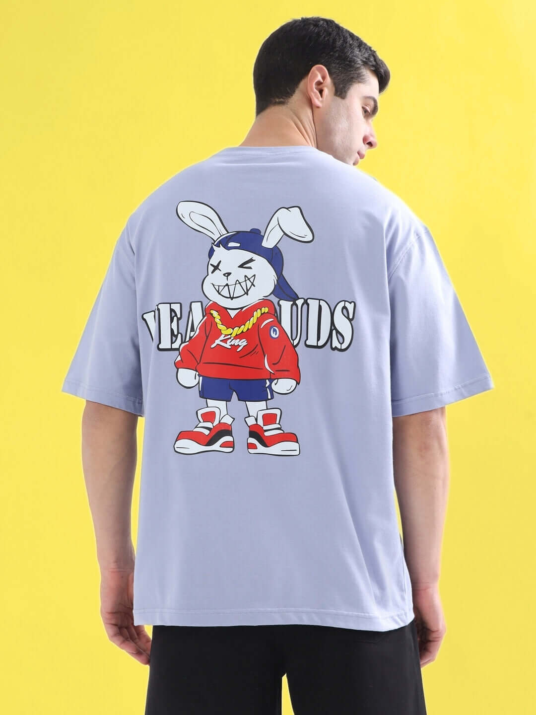 Back view of a RAPPER BUNNY OVER-SIZED T-SHIRT LILAC featuring a bunny graphic with text on a vibrant yellow background.