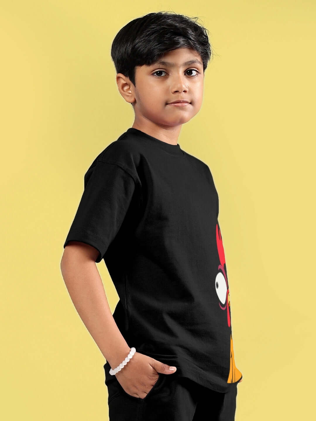 Child wearing a black t-shirt with a funny chicken print, ideal for boys and girls, from DUDS made-to-order collection.