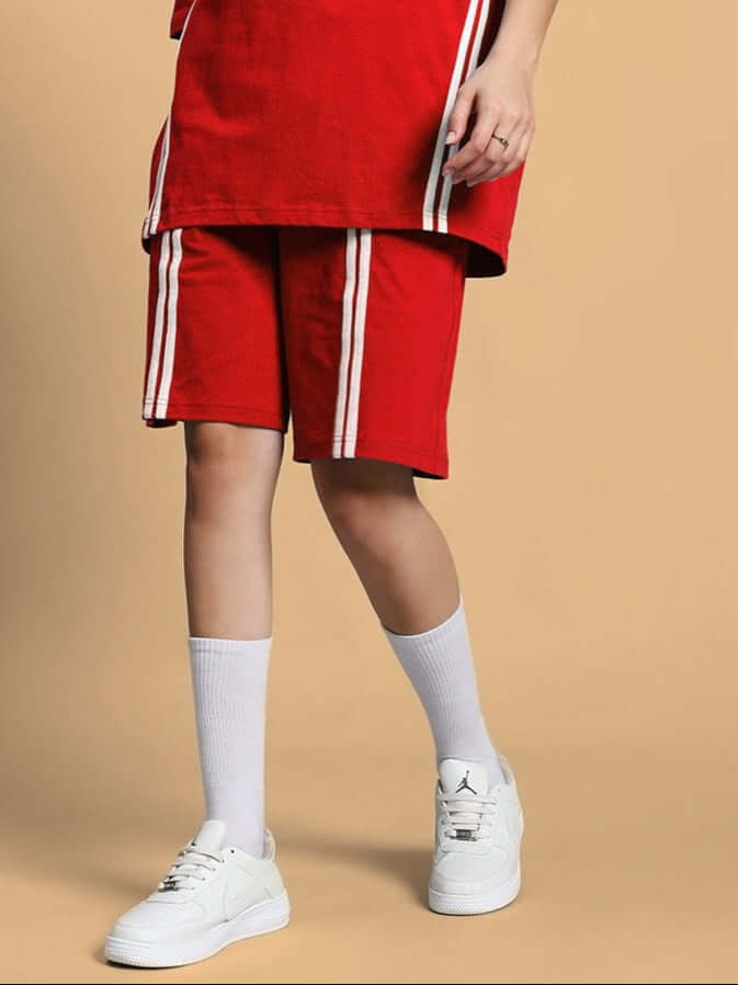 Women's red regular fit shorts with white stripes, paired with white sneakers and socks, offering custom fit options for personalized comfort.
