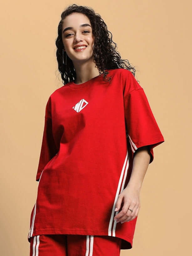 Model wearing Women's Outlook Over-sized T-shirt in red, made of premium heavy gauge fabric, featuring a comfortable fit and stylish design.