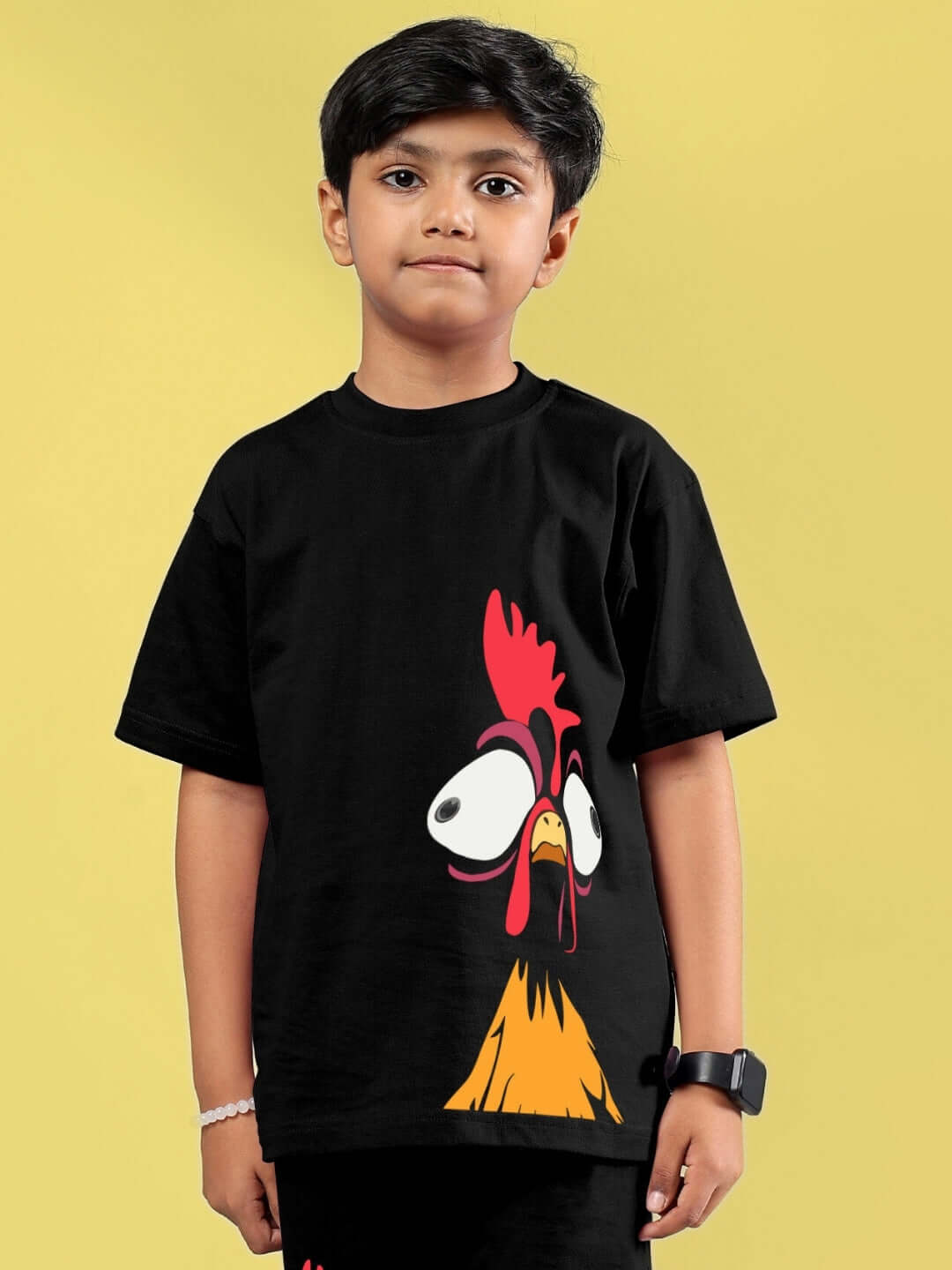 Boy wearing a funny chicken printed black t-shirt, suitable for boys and girls. Made to order by DUDS, shipping in 7-10 days.