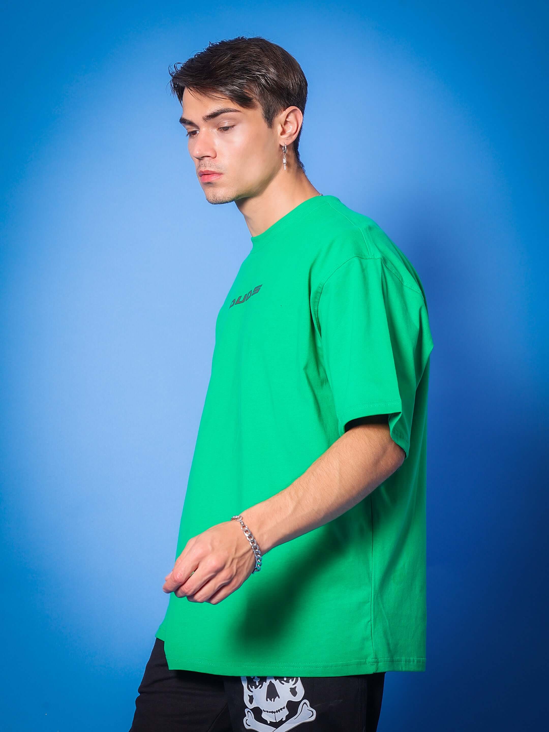 MEDUSA GAZE REFLECTOR EYE OVER-SIZED T-SHIRT GREEN on model in profile view, featuring bold style and custom fit option.