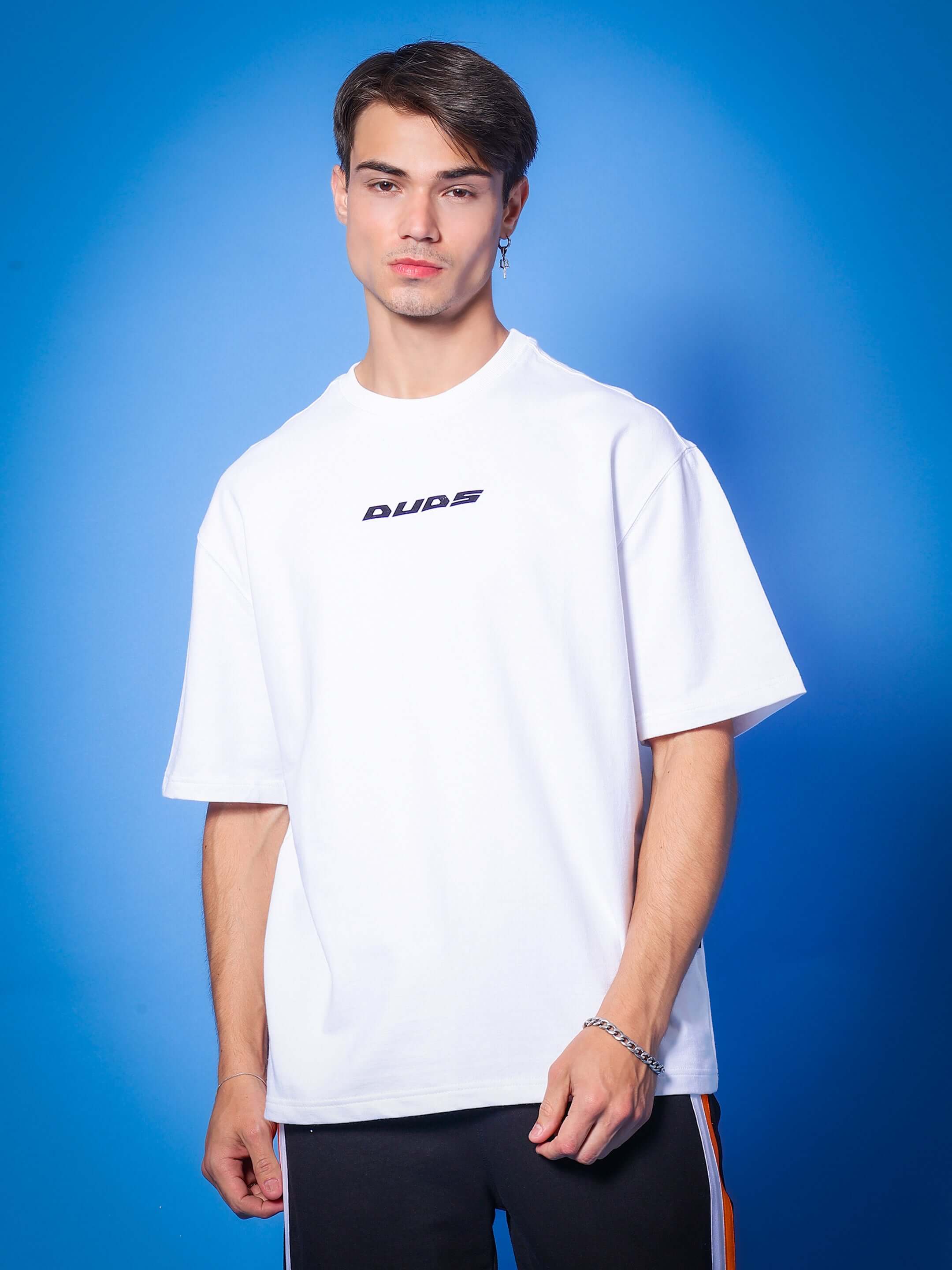Model wearing MIND & SPIRIT GOTHIC ART PRINT OVER-SIZED T-SHIRT WHITE with blue background