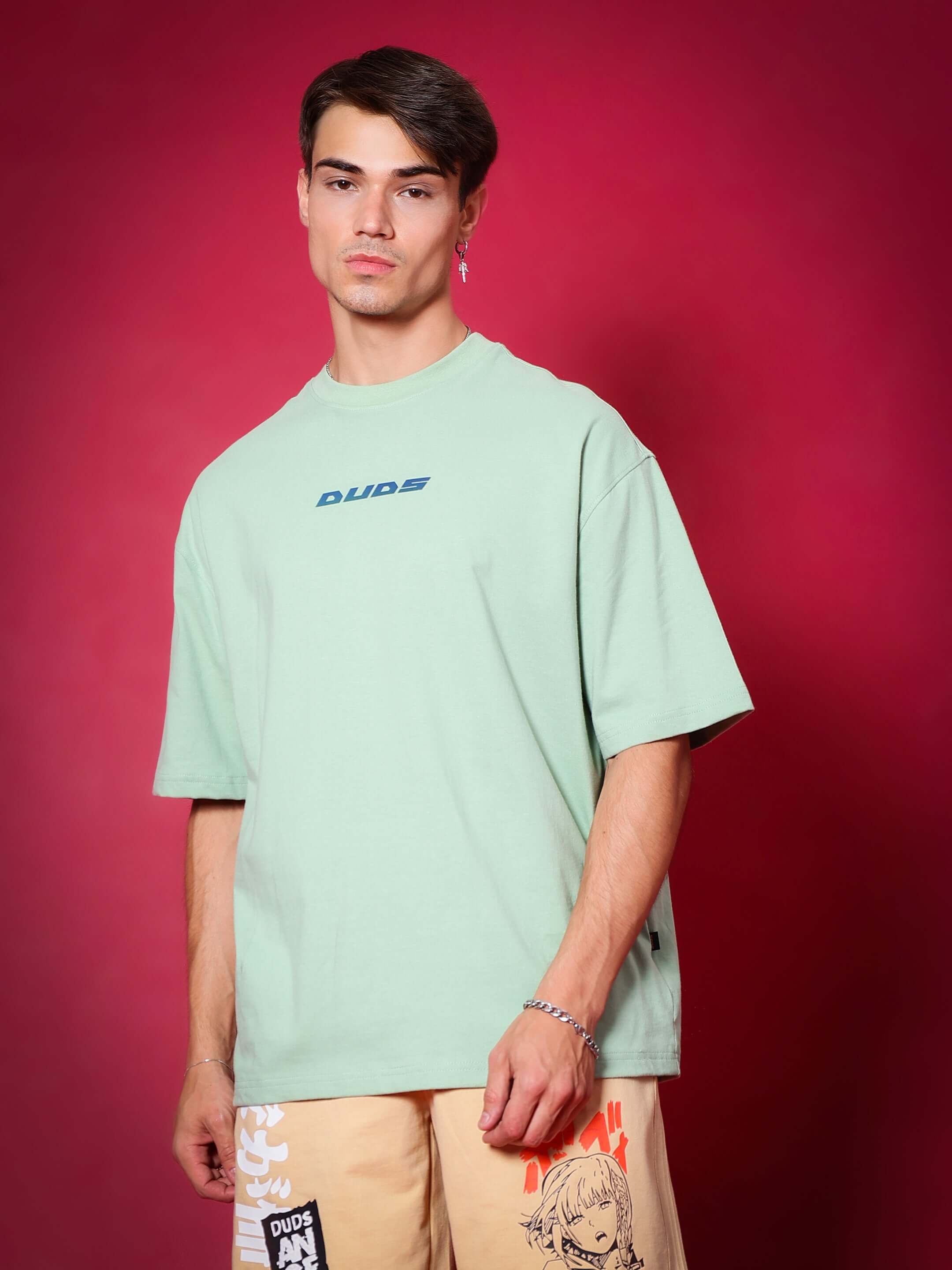 Model wearing PRAY OVER-SIZED T-SHIRT NYANZA GREEN made of premium heavy gauge fabric, with 97% premium cotton and 3% elastane.