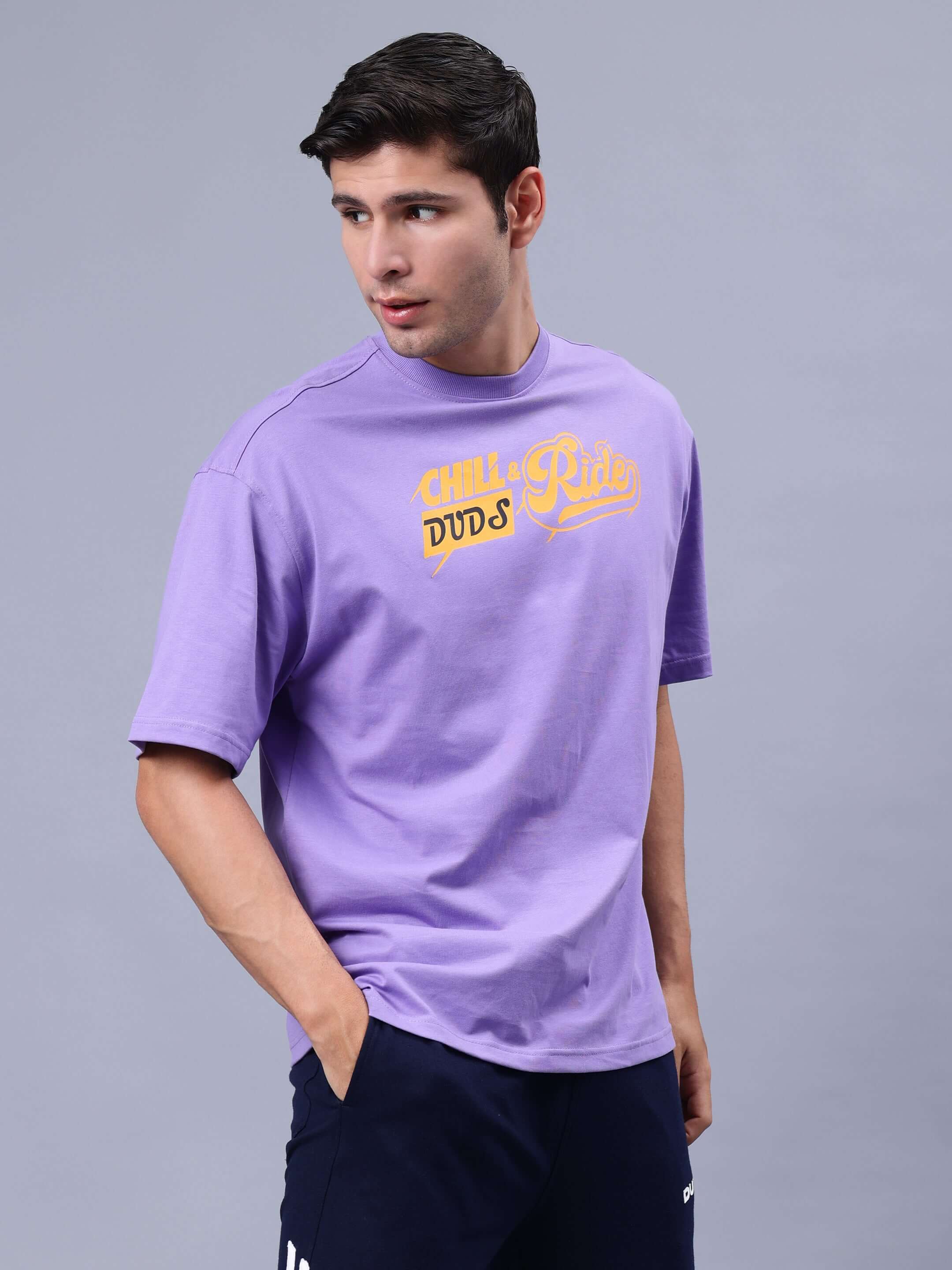Man wearing DUDS CHILL & RIDE OVER-SIZED T-SHIRT LAVENDER, showcasing casual style.
