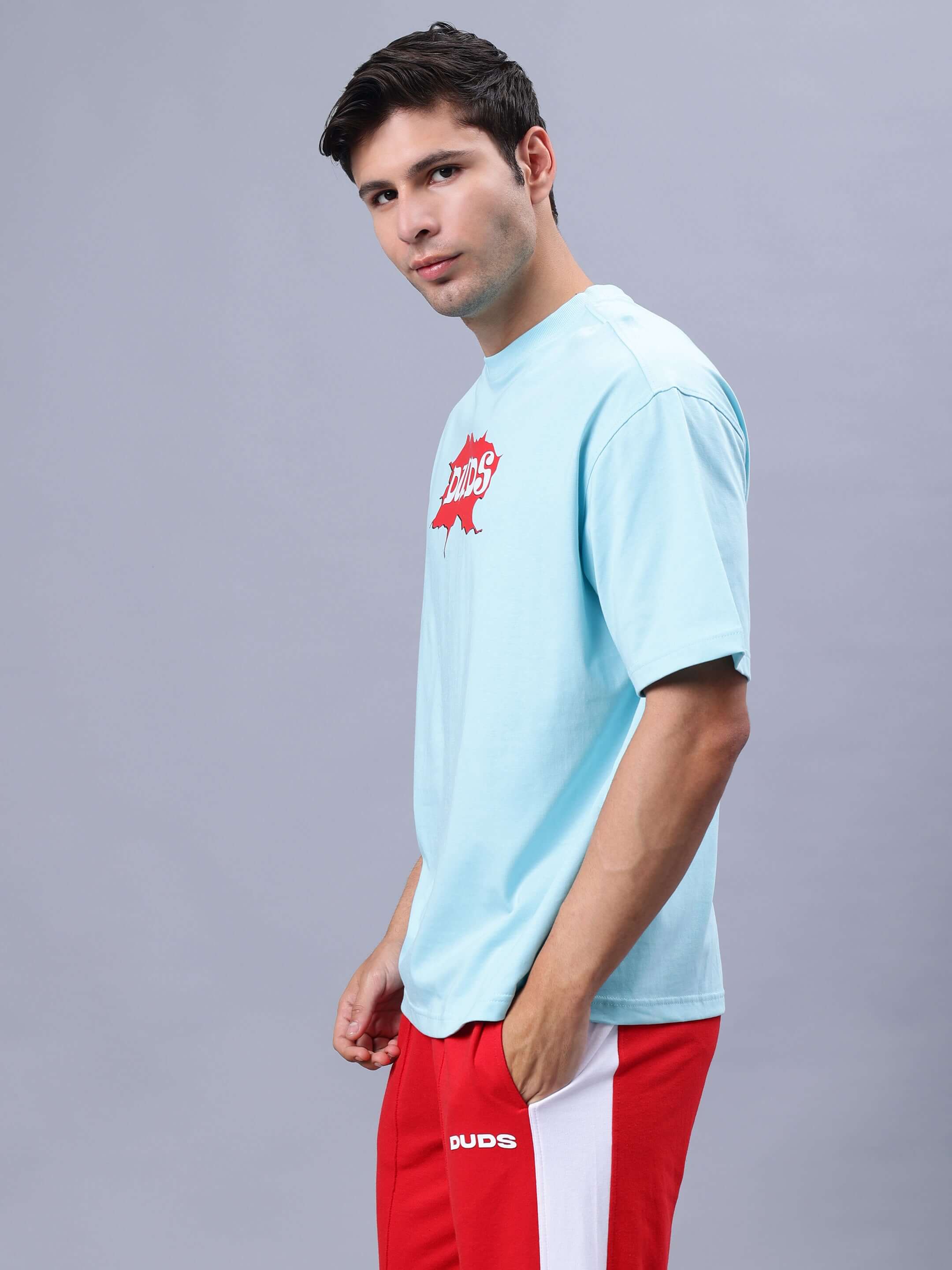 Model wearing RADIO OVER-SIZED T-SHIRT SKY BLUE with red shorts